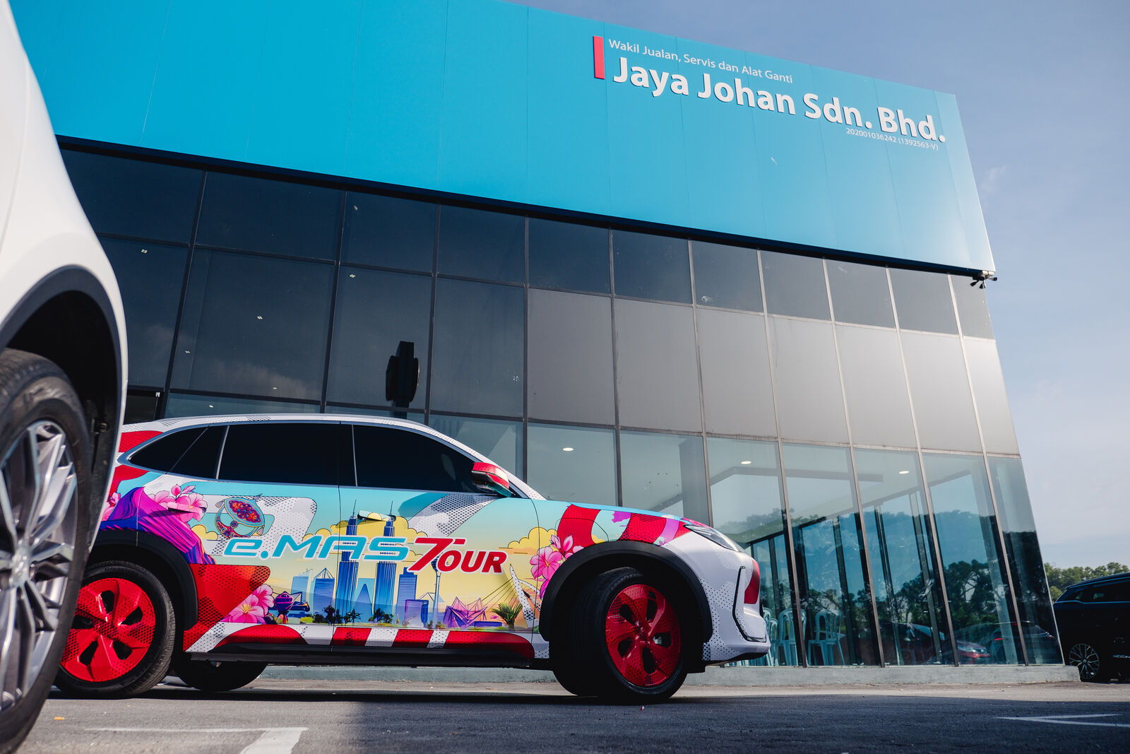 Proton e.MAS 7 in tour livery outside the Jaya Johan dealership